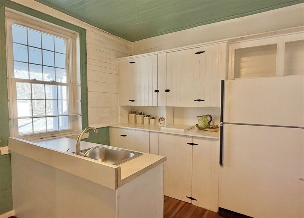278 East Main Street Plainfield, MA 01070 - Photo 27 of 33 a kitchen that has a refrigerator a sink and white cabinets
