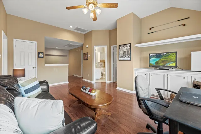 a living room with furniture and a wooden floor