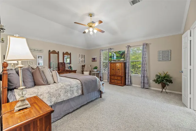 a bedroom with bed and a chandelier