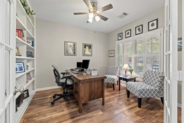 a view of a workspace with furniture and a window