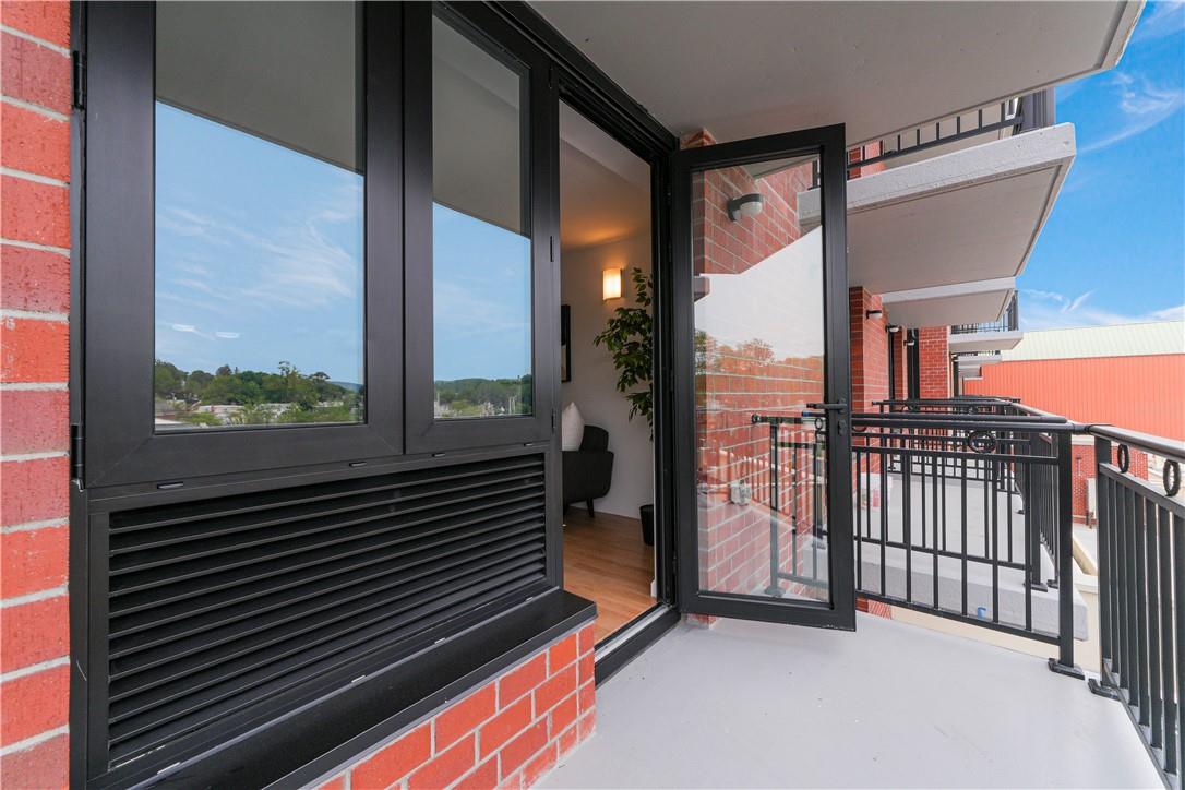 a view of a balcony with a floor to ceiling window and wooden floor