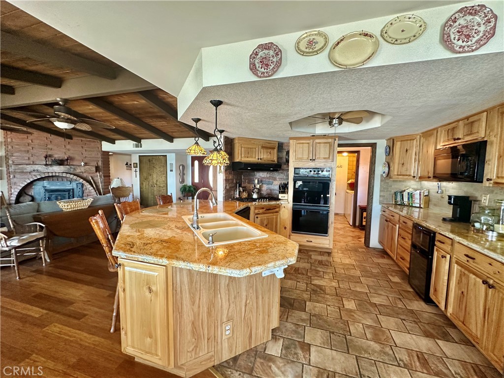 26576 Bluewater Road Helendale, CA 92342 - Photo 14 of 51 a room with stainless steel appliances lots of counter top space