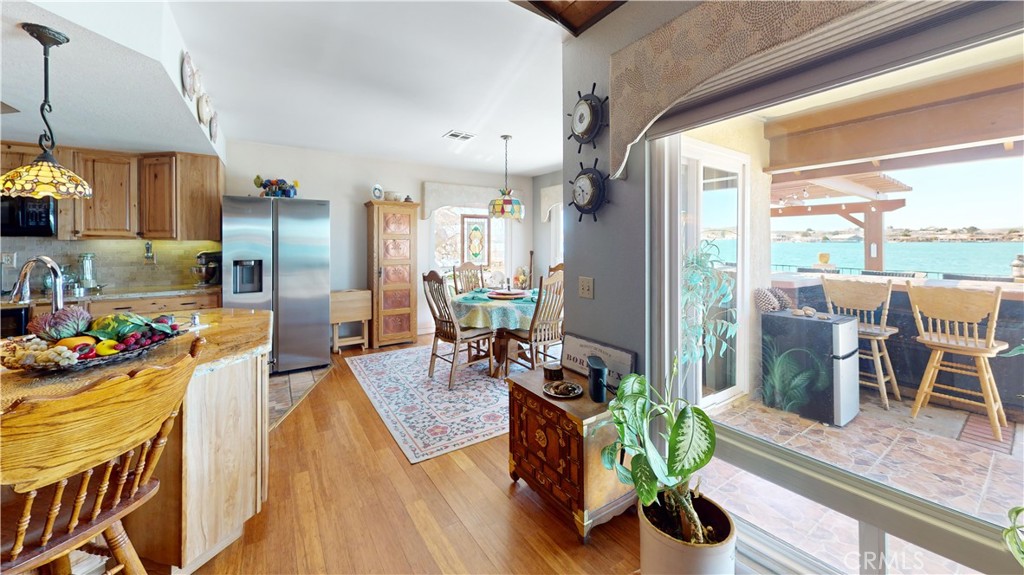 26576 Bluewater Road Helendale, CA 92342 - Photo 18 of 51 a view of a dining room and livingroom with furniture wooden floor a chandelier