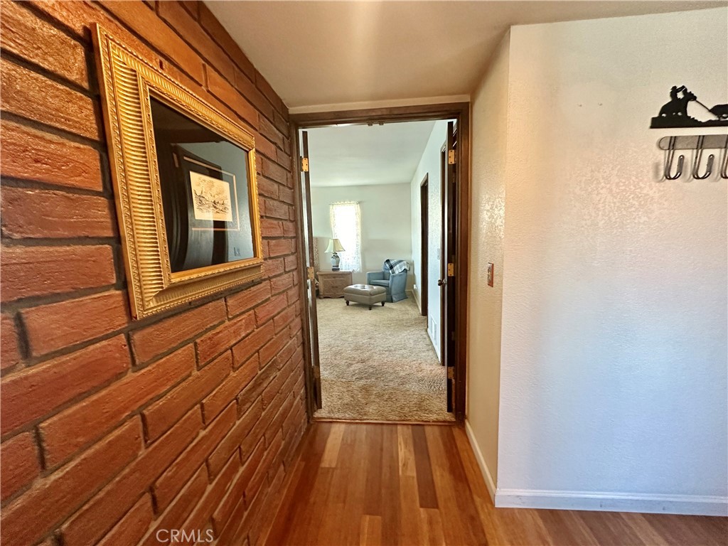 26576 Bluewater Road Helendale, CA 92342 - Photo 24 of 51 a view of a hallway with wooden floor and a bathroom