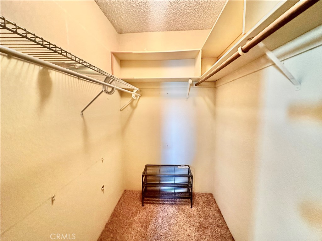 26576 Bluewater Road Helendale, CA 92342 - Photo 30 of 51 a view of walk in closet with clothes and shoes