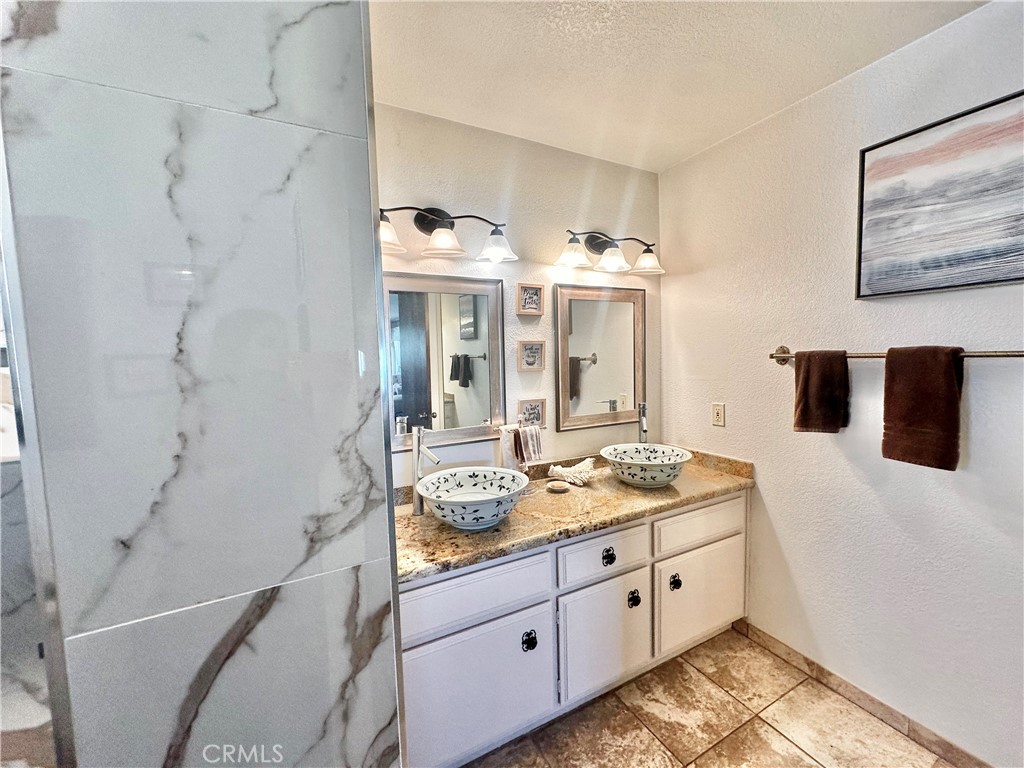 26576 Bluewater Road Helendale, CA 92342 - Photo 32 of 51 a spacious bathroom with double vanity and a mirror