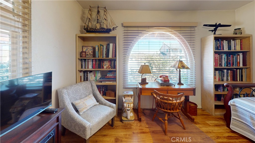 26576 Bluewater Road Helendale, CA 92342 - Photo 33 of 51 a living room with furniture a window and a book shelf
