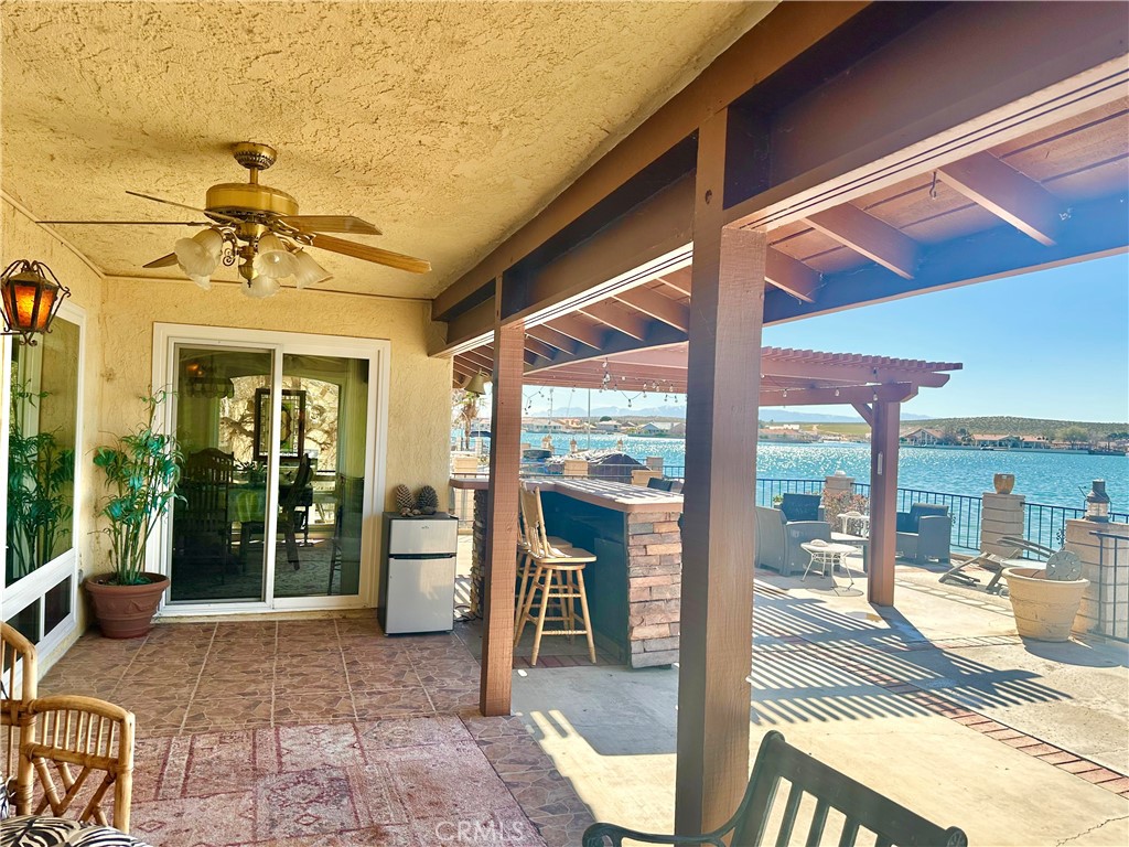 26576 Bluewater Road Helendale, CA 92342 - Photo 38 of 51 a view of a porch with a table and chairs