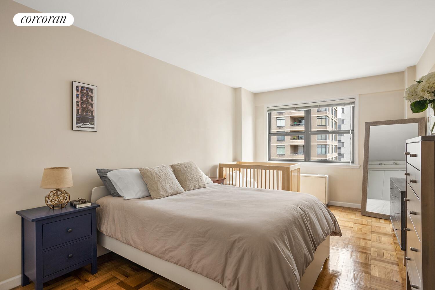 345 East 69th Street, Unit 16E Manhattan, NY 10021 - Photo 5 of 9 a bedroom with a bed and a window