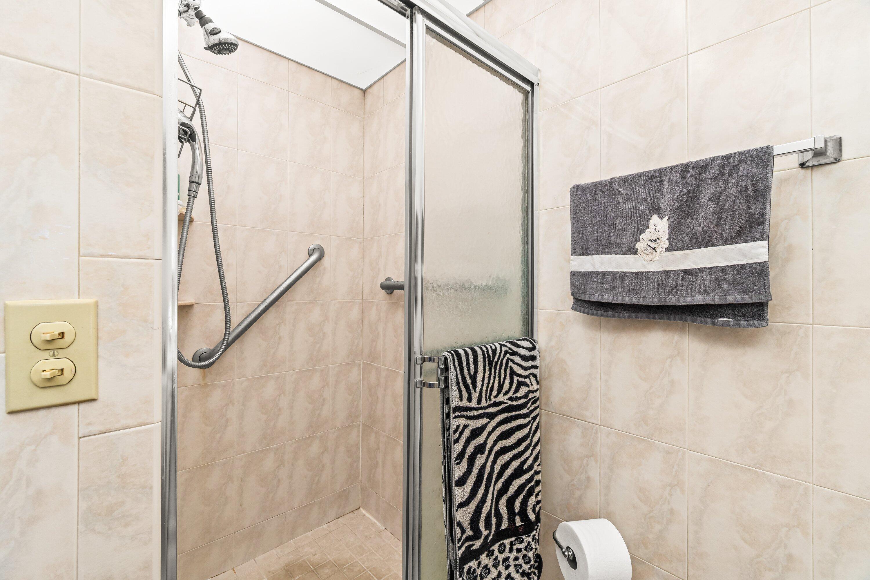 508 Normandy Lane, Unit 508 Delray Beach, FL 33484 - Photo 22 of 25 a bathroom with a sink and a shower