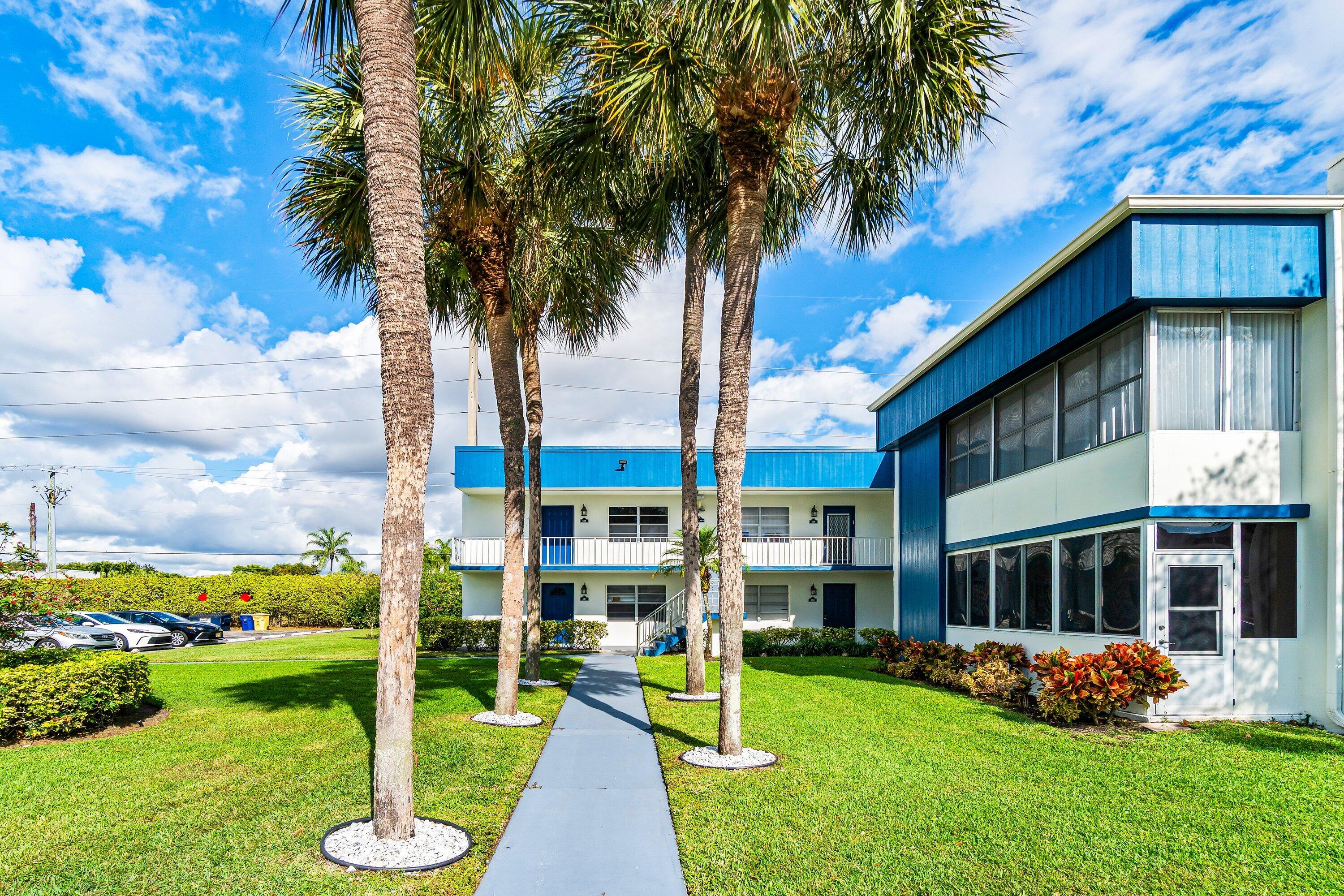 508 Normandy Lane, Unit 508 Delray Beach, FL 33484 - Photo 25 of 25 a view of a house with a yard and potted plants