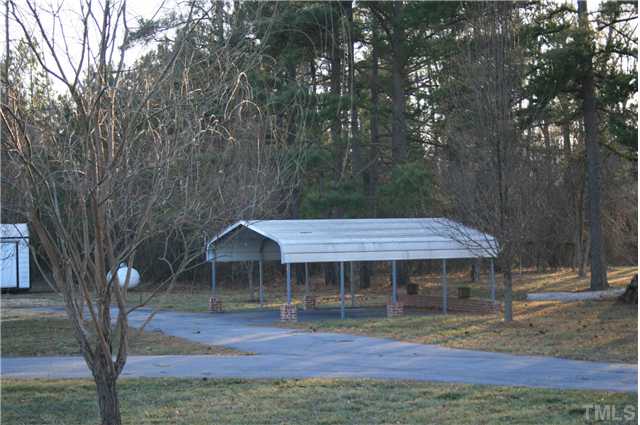 4053 Fairport Road Kittrell, NC 27544 - Photo 12 of 15 Paved driveway and dual car carport, along with the storage building will give you lots of enjoyment in keeping your cars clean and your toys stored.