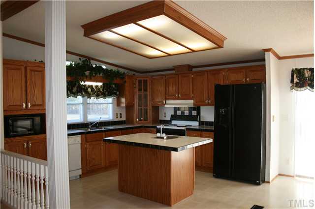 4053 Fairport Road Kittrell, NC 27544 - Photo 3 of 15 You will be able to cook like a chef in this kitchen! All appliances seen here convey. Island has electricity as well as a small sink. Countertops are edged with ceramic tile.