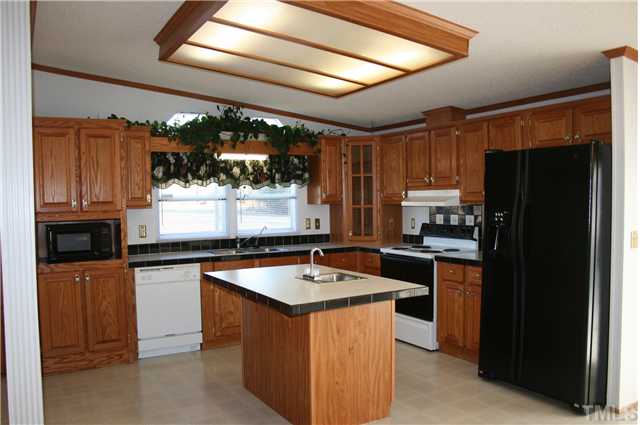 4053 Fairport Road Kittrell, NC 27544 - Photo 4 of 15 A more close up view of the kitchen. Did you notice the corner cabinet that has glass doors to display your glassware?