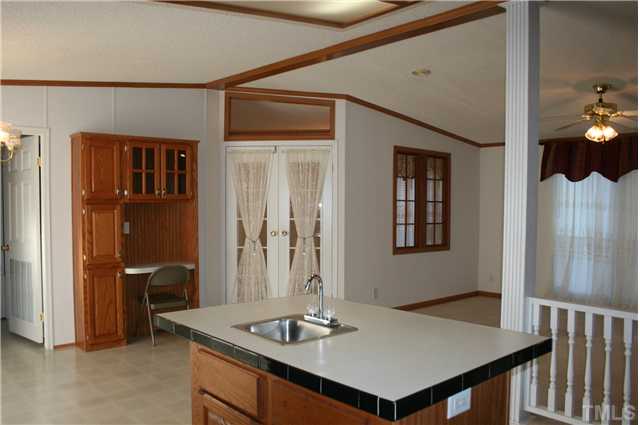4053 Fairport Road Kittrell, NC 27544 - Photo 5 of 15 Looking back from the kitchen into the family room on the right, and the eat in area on the left. Kitchen desk is perfect for connecting to www.FoodNetwork.com. French doors lead to the formal room at the front.