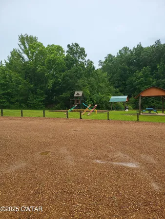 a view of a field with sitting area