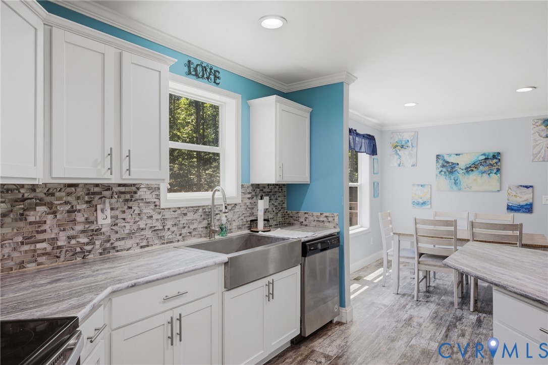 93 Faraway Road Saluda, VA 23149 - Photo 15 of 58 a kitchen with stainless steel appliances a sink stove and cabinets