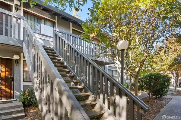 a view of street along with deck and trees
