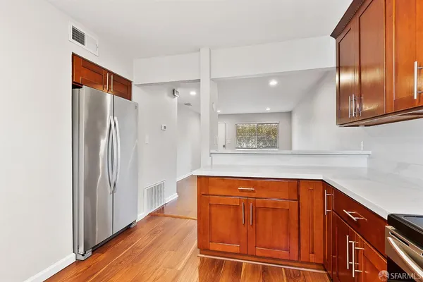 a view of a refrigerator and window in a kitchen