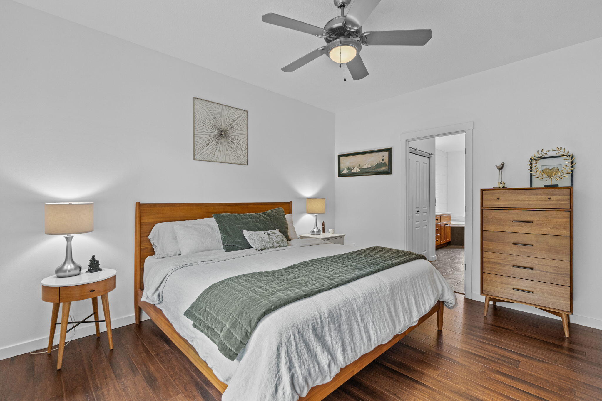10942 Village Loop Redmond, OR 97756 - Photo 10 of 45 a bedroom with a bed a dresser and a lamp