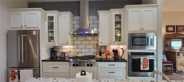 a kitchen with stainless steel appliances a stove and a refrigerator