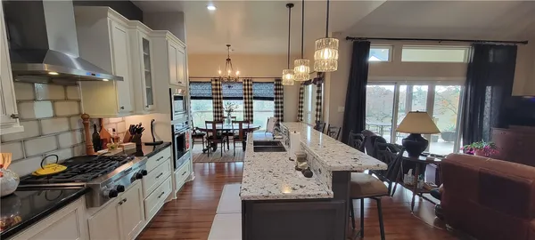 a large kitchen with lots of counter space and chandelier