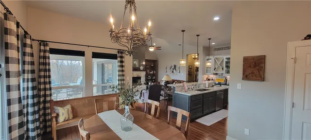 a view of a dining room with furniture a chandelier and wooden floor