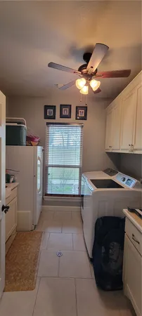 a kitchen with a cabinets and white appliances