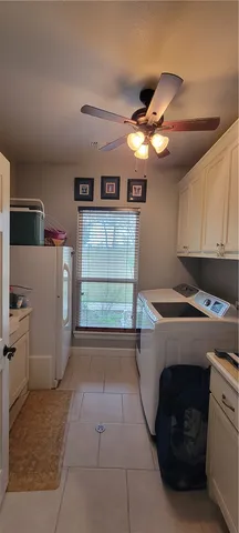 a kitchen with a cabinets and white appliances