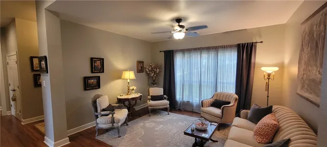 a living room with furniture and a lamp