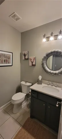 a bathroom with a sink toilet and a mirror