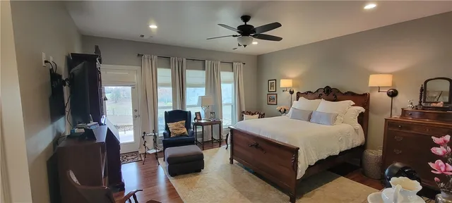 a spacious bedroom with a bed a couch and a chandelier