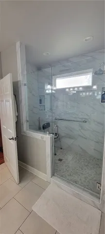 a bathroom with a bathtub and a shower