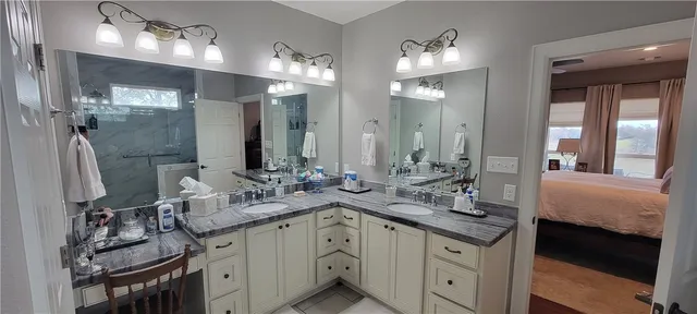 a bathroom with double vanity sinks and a mirror