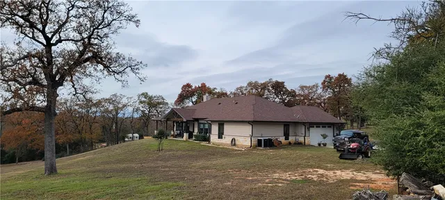 a view of a house with a yard and a garage