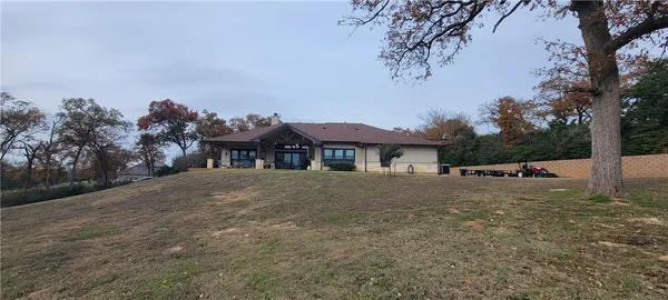 a view of a house with a yard and tree s