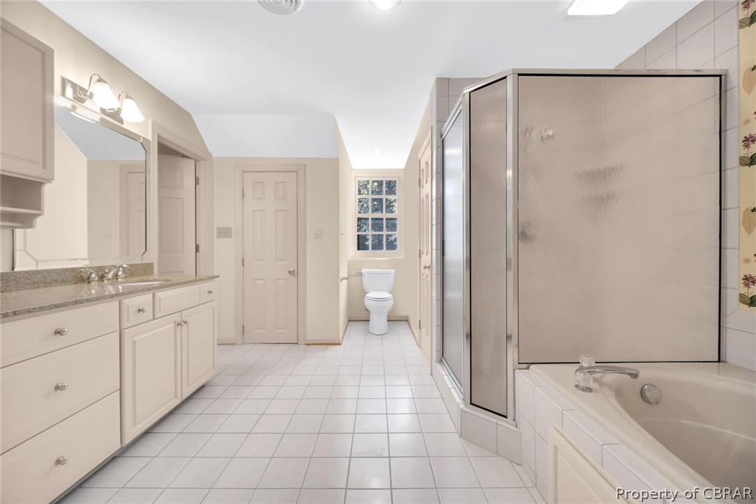 Jetted tub, walk-shower and heated tile floors in the owner's suite bath.