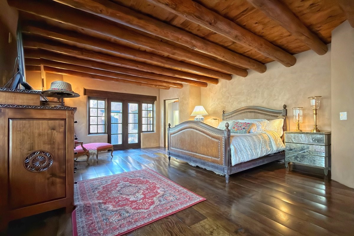 1433 Upper Canyon Road Santa Fe, NM 87501 - Photo 26 of 57 Owner's Suite With Two Corner Kiva Fireplaces