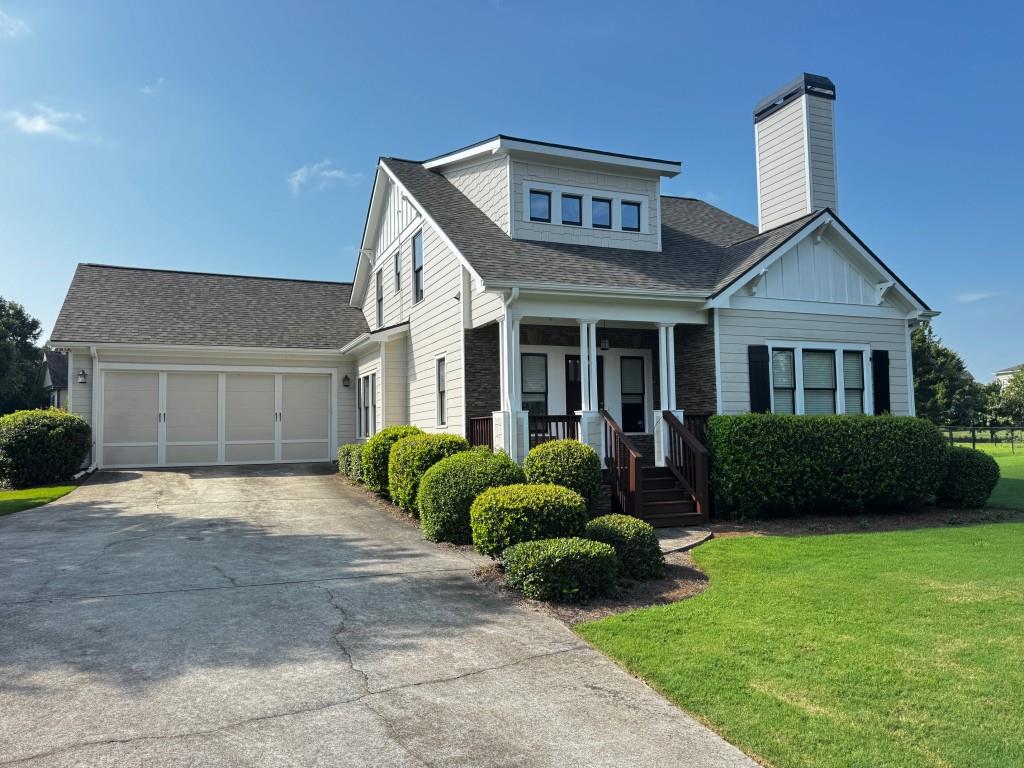 1713 Townside Drive Bishop, GA 30621 - Photo 7 of 25 a front view of a house with a yard and garage