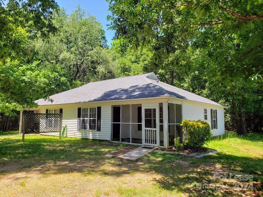 1207 Auten Road, Unit B Charlotte, NC 28216 - Photo 1 of 17 a view of a yard in front of a house with large windows