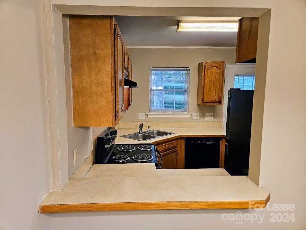 1207 Auten Road, Unit B Charlotte, NC 28216 - Photo 11 of 17 a kitchen with a refrigerator and a sink