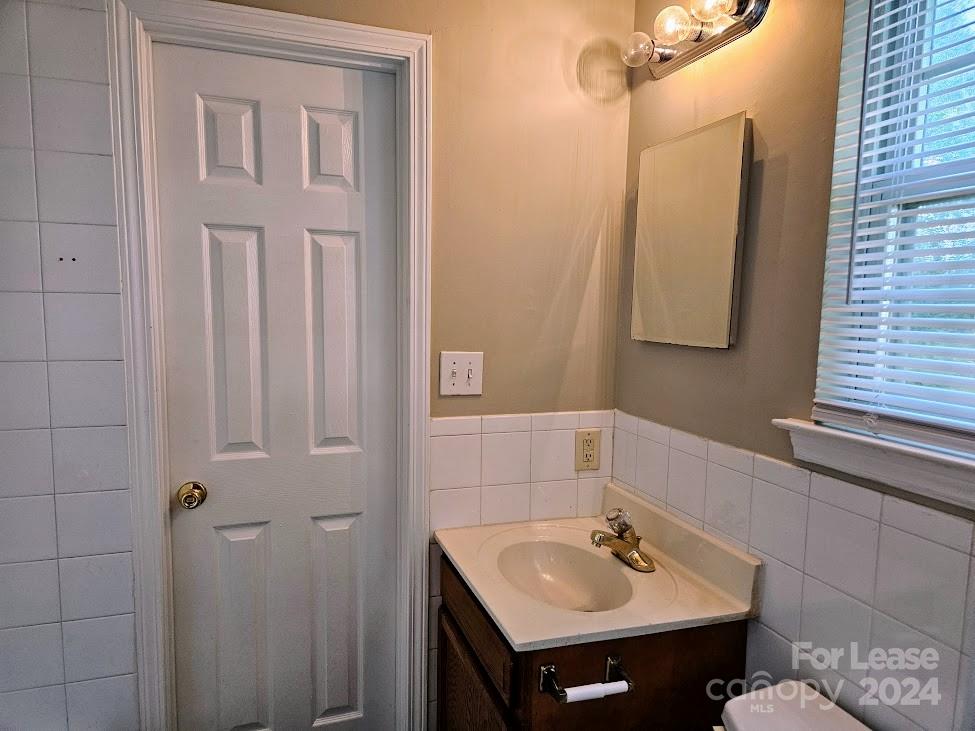 1207 Auten Road, Unit B Charlotte, NC 28216 - Photo 15 of 17 a bathroom with a sink and a mirror