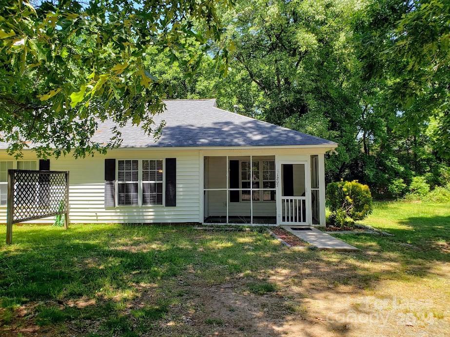 1207 Auten Road, Unit B Charlotte, NC 28216 - Photo 2 of 17 a house with trees in the background