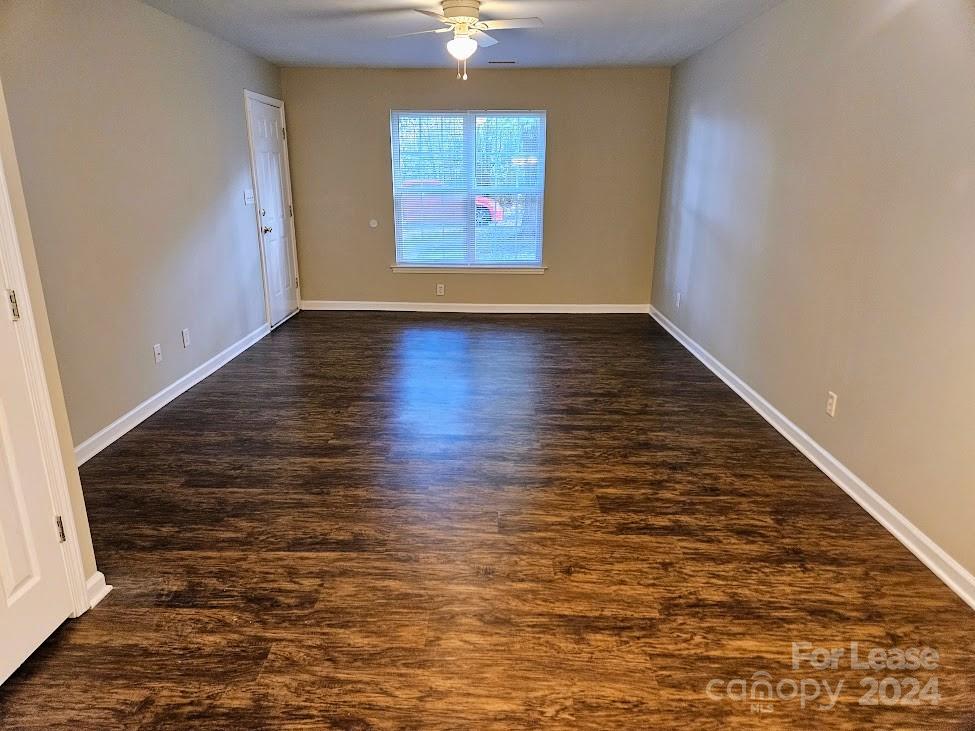 1207 Auten Road, Unit B Charlotte, NC 28216 - Photo 6 of 17 wooden floor in an empty room with a window
