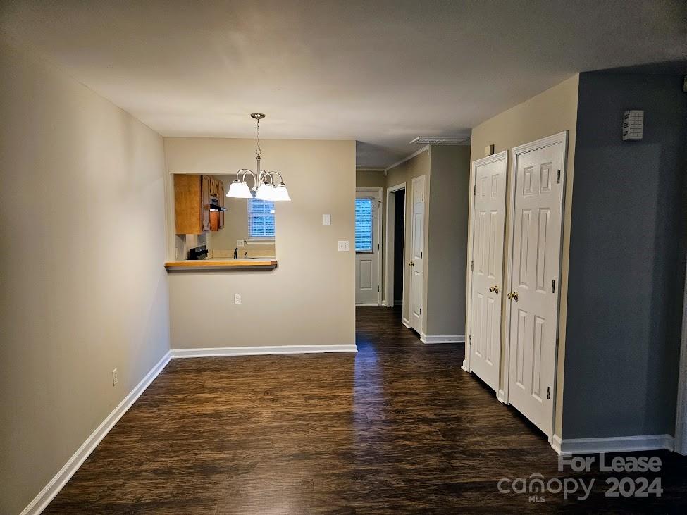 1207 Auten Road, Unit B Charlotte, NC 28216 - Photo 8 of 17 an empty room with wooden floor and cabinet