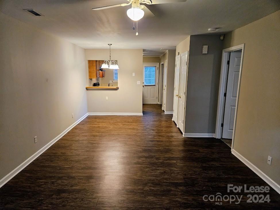 1207 Auten Road, Unit B Charlotte, NC 28216 - Photo 9 of 17 an empty room with wooden floor and a bathroom