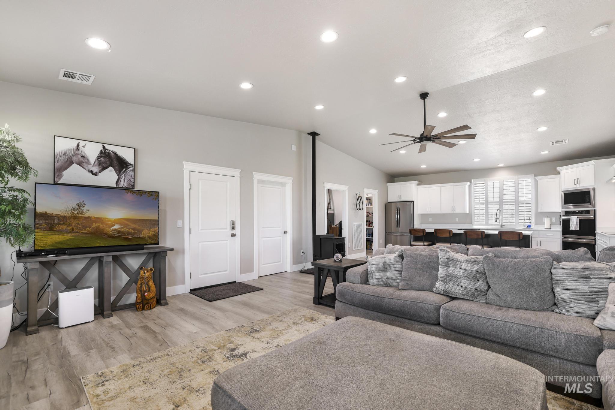 758 Cedar Crk Road Rogerson, ID 83302 - Photo 4 of 50 Open-concept living area featuring wood-finish flooring, vaulted ceilings with recessed lighting, and a ceiling fan