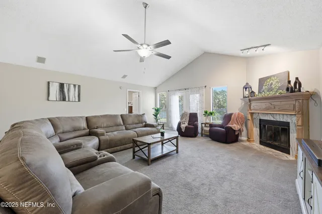 a living room with furniture and a fireplace