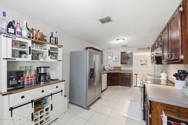 a kitchen with stainless steel appliances a refrigerator and a stove top oven