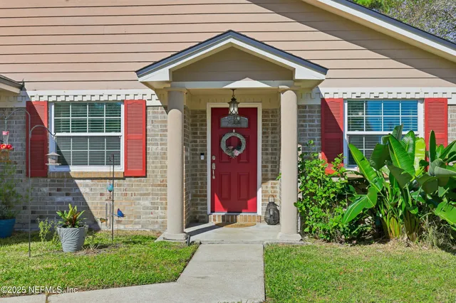 a view of a house with entryway and plants